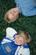 Picture of two children laying in grass
